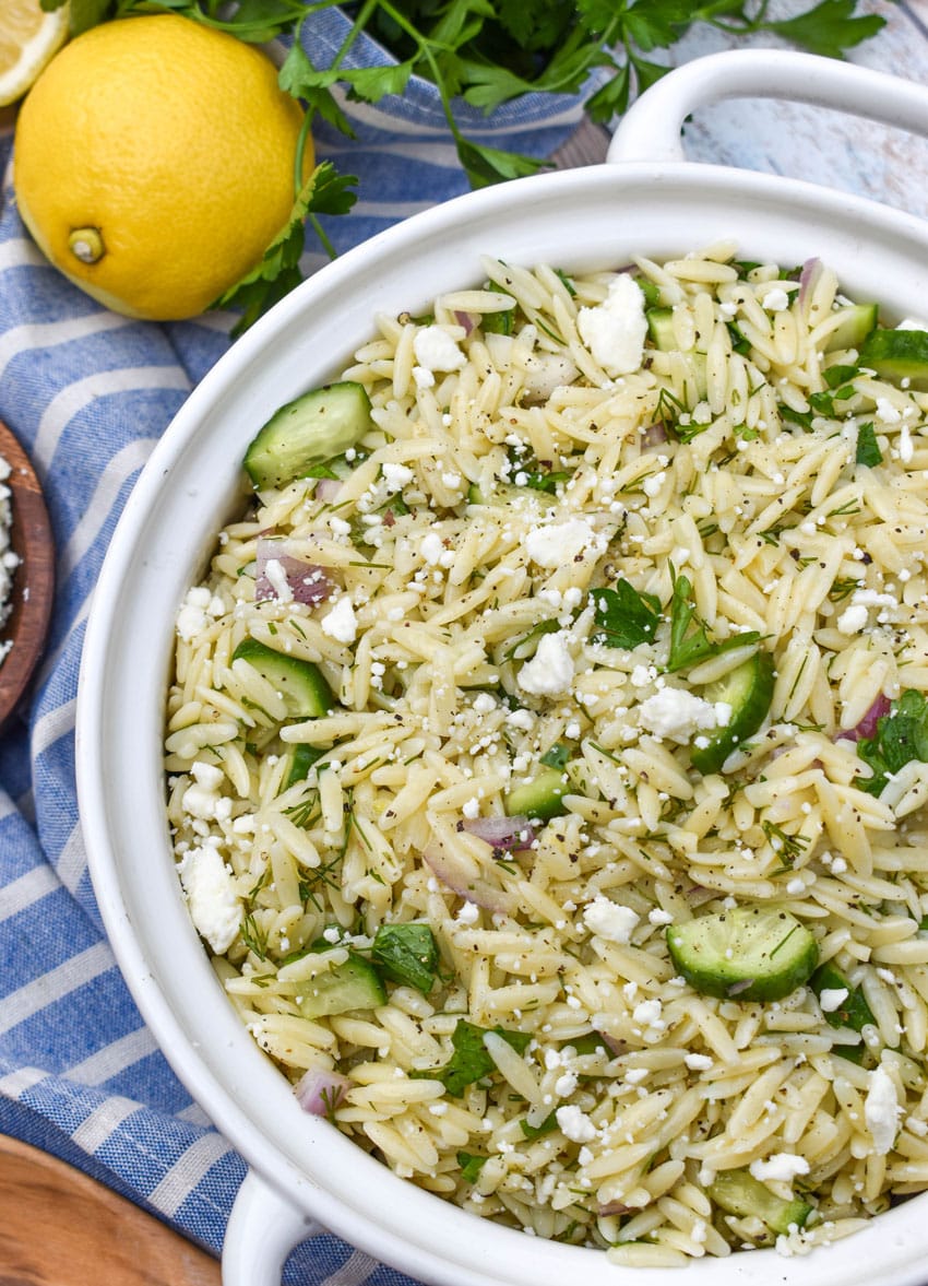 cucumber lemon orzo salad in a white serving bowl