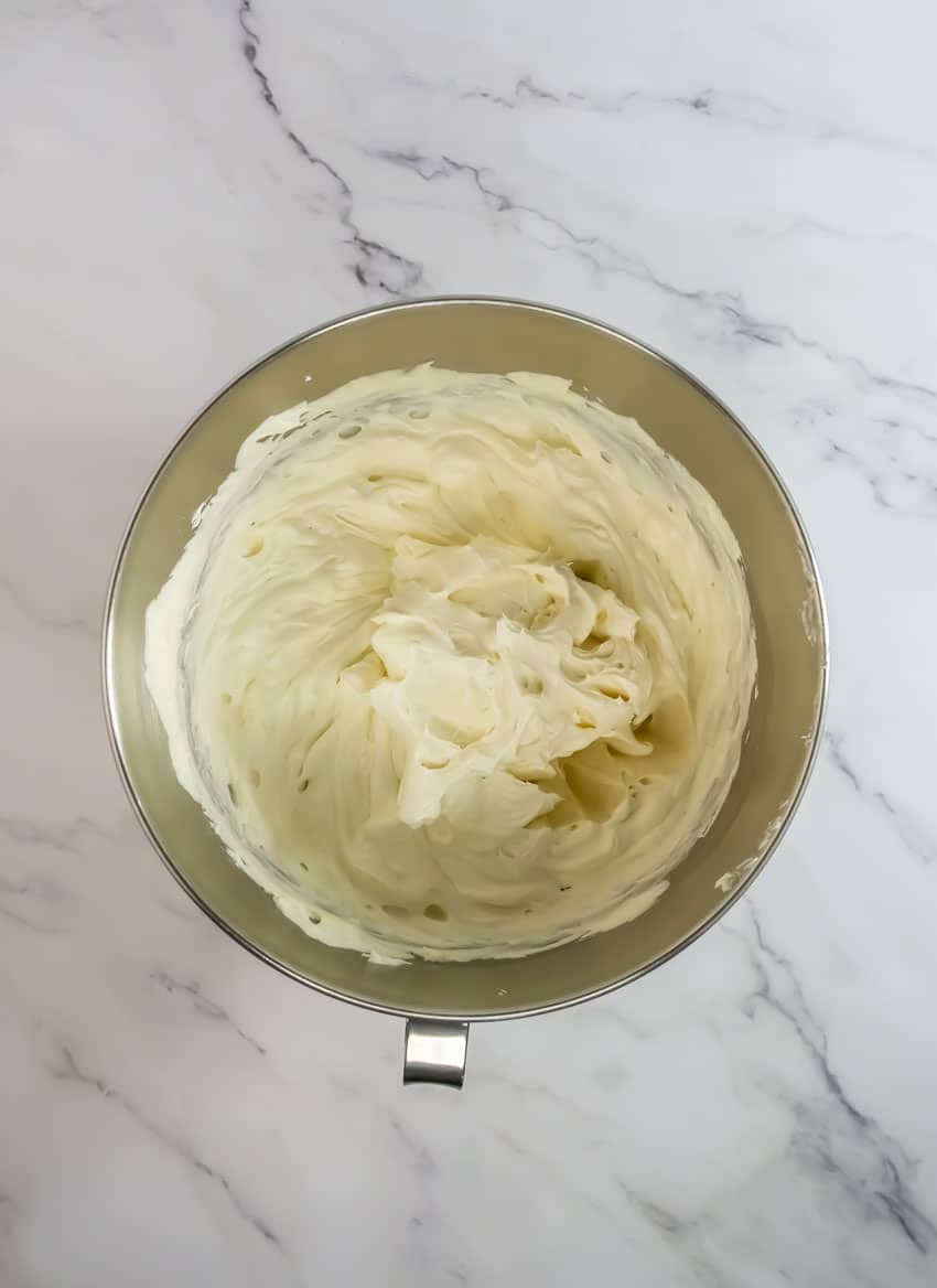 homemade cheesecake filling in a metal mixing bowl