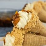 peach cobbler cheese cake cones on a white serving plate