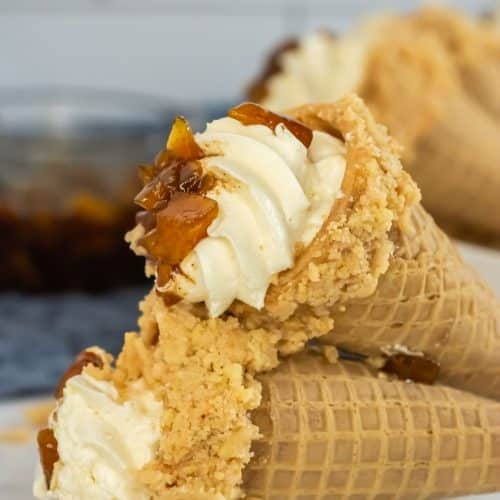 peach cobbler cheese cake cones on a white serving plate