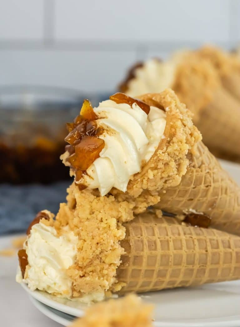 peach cobbler cheese cake cones on a white serving plate