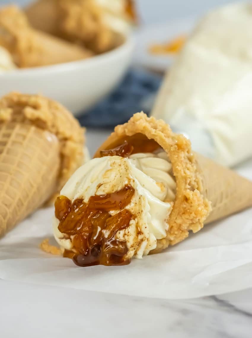 peach cobbler cheese cake cones on a white serving plate