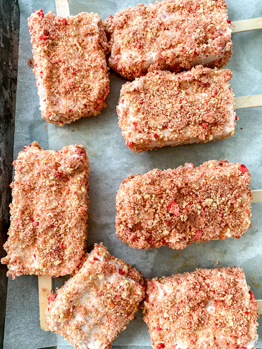 homemade strawberry crunch bars resting on wax paper