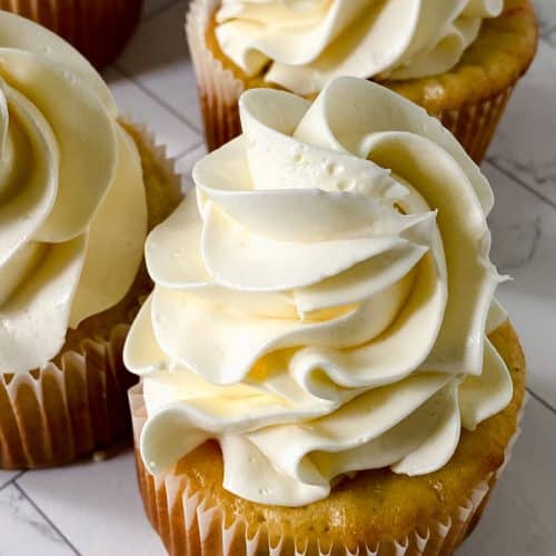 swirls of better canned frosting shown on homemade cupcakes