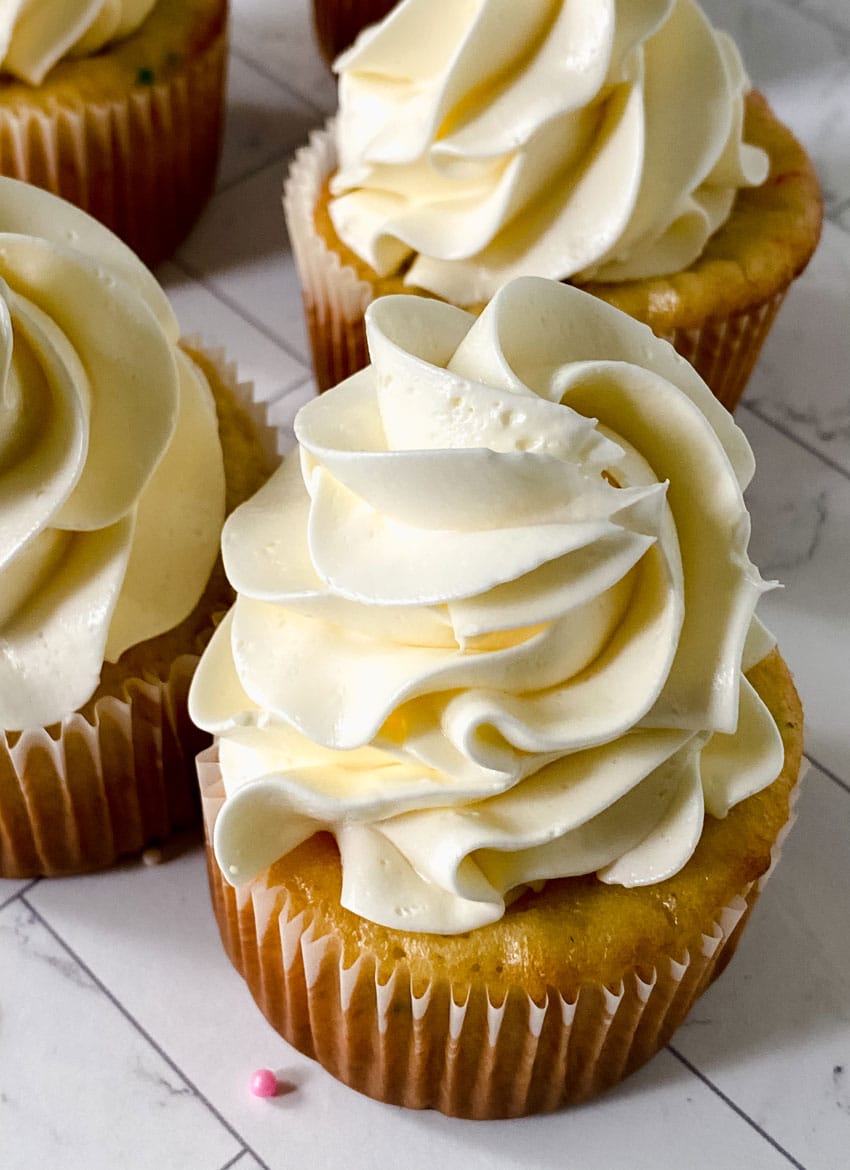 How To Make Canned Frosting Better swirls of better canned frosting shown on homemade cupcakes