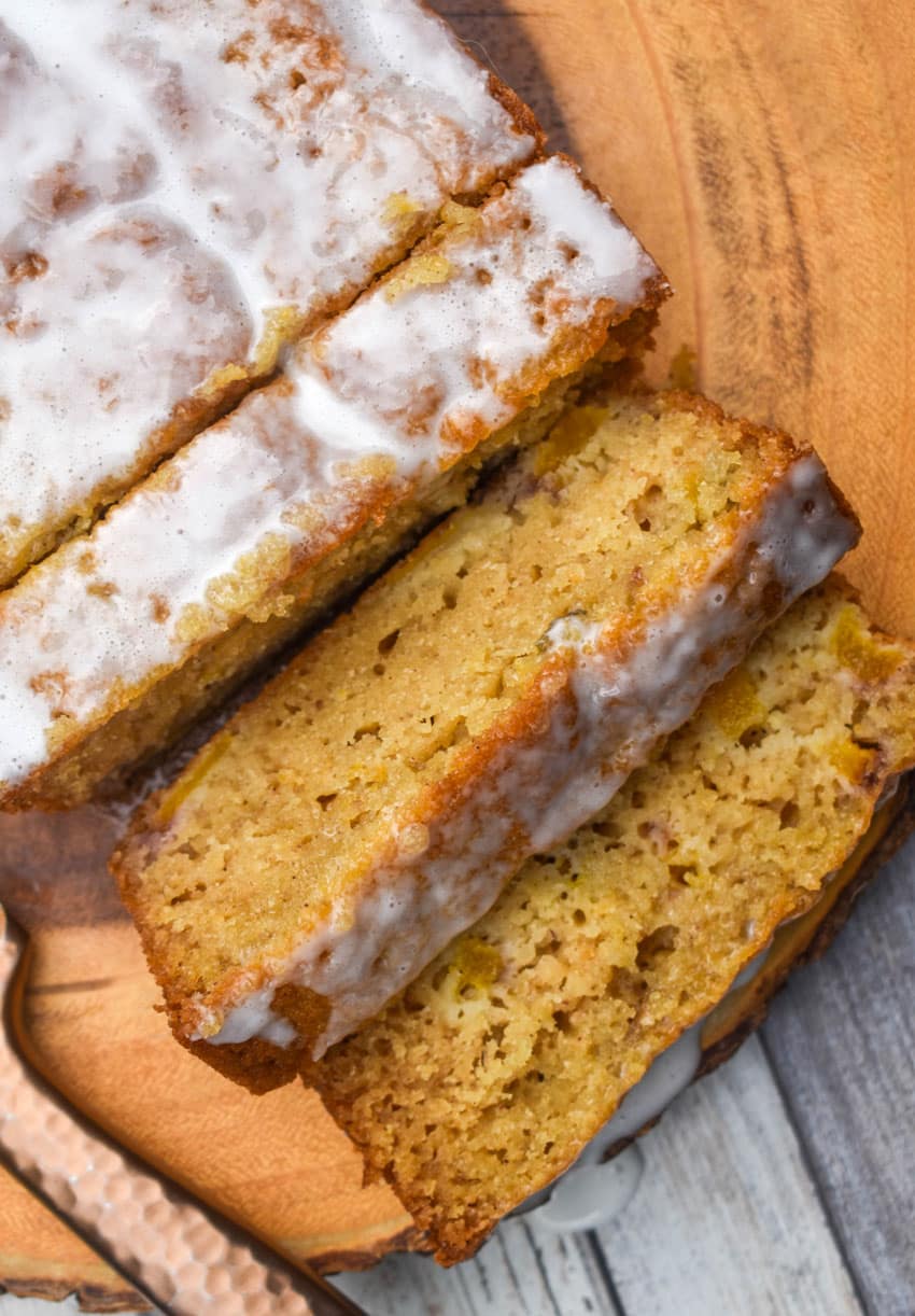 slices of glazed peach bread on a wooden cutting board