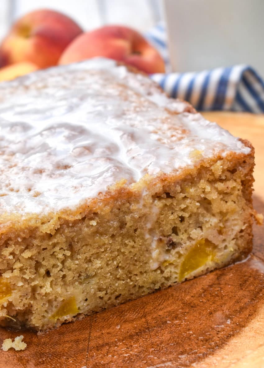 southern glazed peach bread on a wooden cutting board