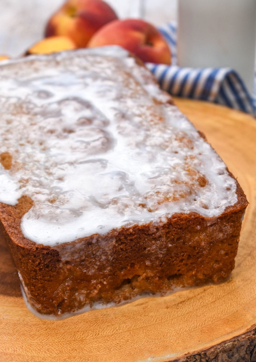 southern glazed peach bread on a wooden cutting board