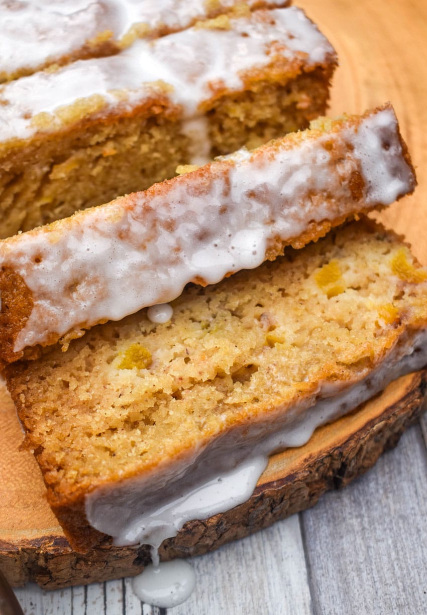 slices of glazed peach bread on a wooden cutting board