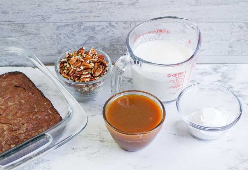 an overhead image showing the measured ingredients needed to make a batch of turtle brownie trifles in small glass jars