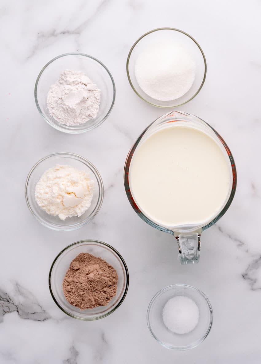 an overhead image showing the measured ingredients needed to make homemade ice cream in mason jars