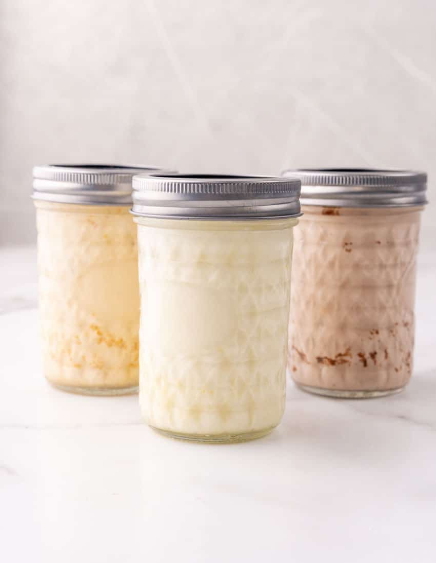 creamy homemade ice cream in three small glass mason jars