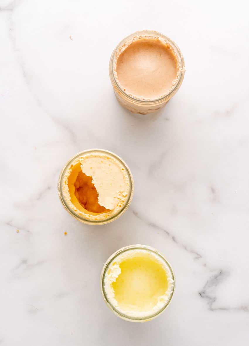 creamy homemade ice cream in three small glass mason jars
