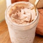 a spoon scooping homemade chocolate ice cream out of a glass mason jar