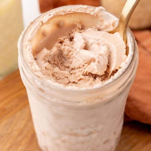 a spoon scooping homemade chocolate ice cream out of a glass mason jar