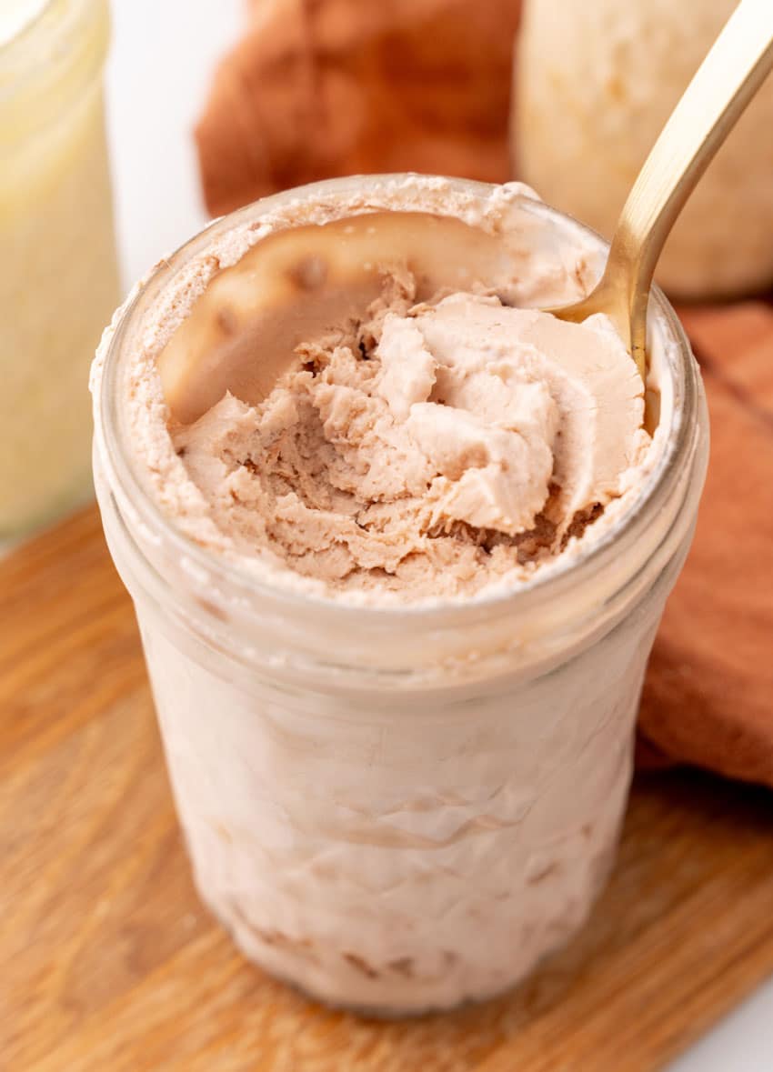 a spoon scooping homemade chocolate ice cream out of a glass mason jar