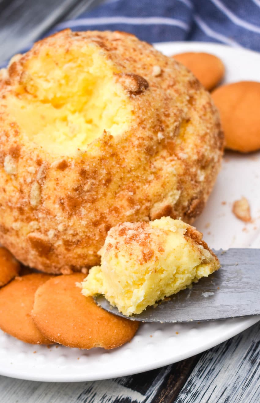 a banana pudding cheese ball surrounded by nilla wafers on a small white plate