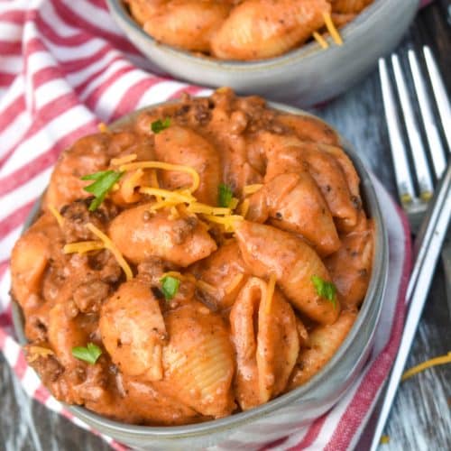 creamy beef and shells pasta in two small gray bowls