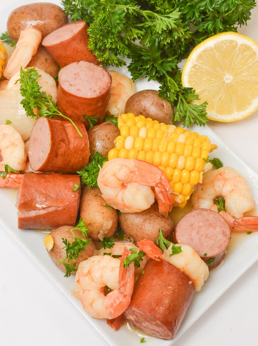 a slow cooker shrimp boil on a white serving platter