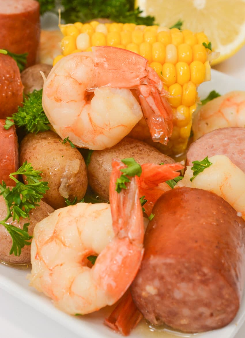 a slow cooker shrimp boil on a white serving platter