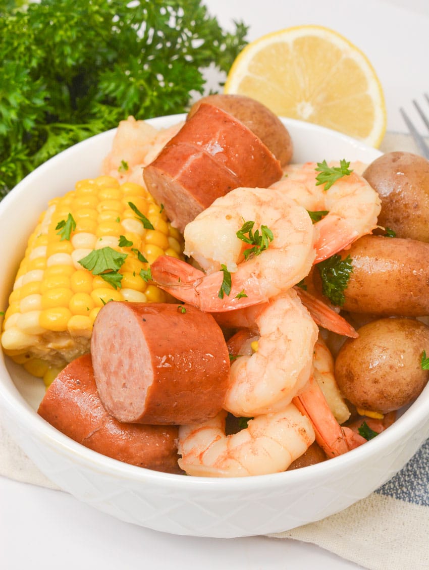 slow cooker shrimp boil piled high in a small white bowl