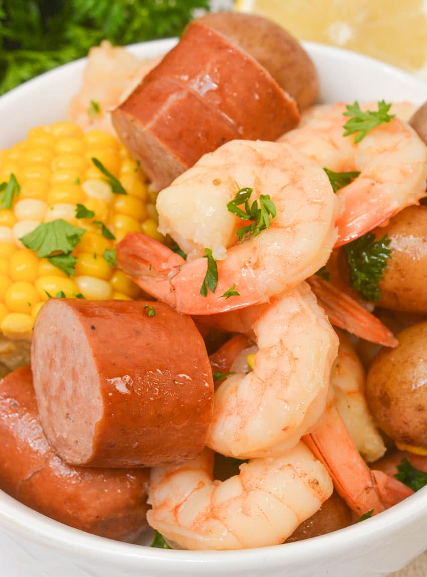 slow cooker shrimp boil piled high in a small white bowl