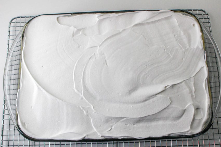 a layered funfetti lush dessert in a glass baking dish
