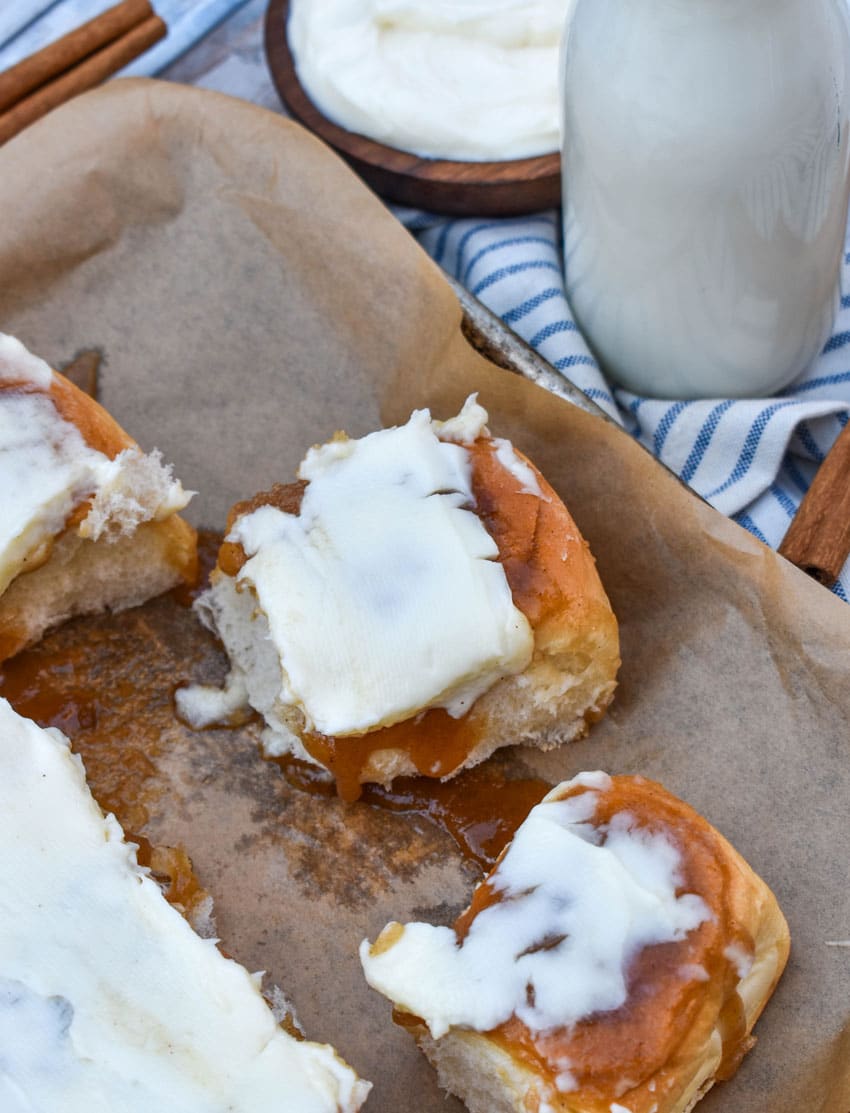 King's hawaiian cinnamon rolls on a parchment paper lined baking sheet