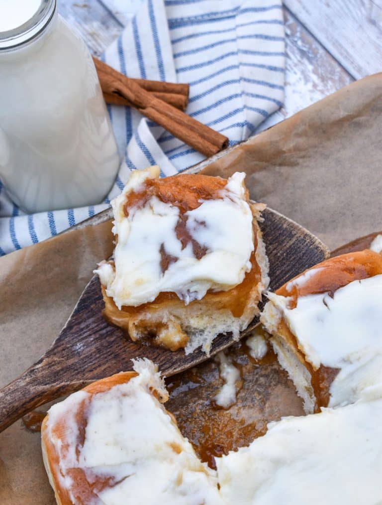 King's hawaiian cinnamon rolls on a parchment paper lined baking sheet