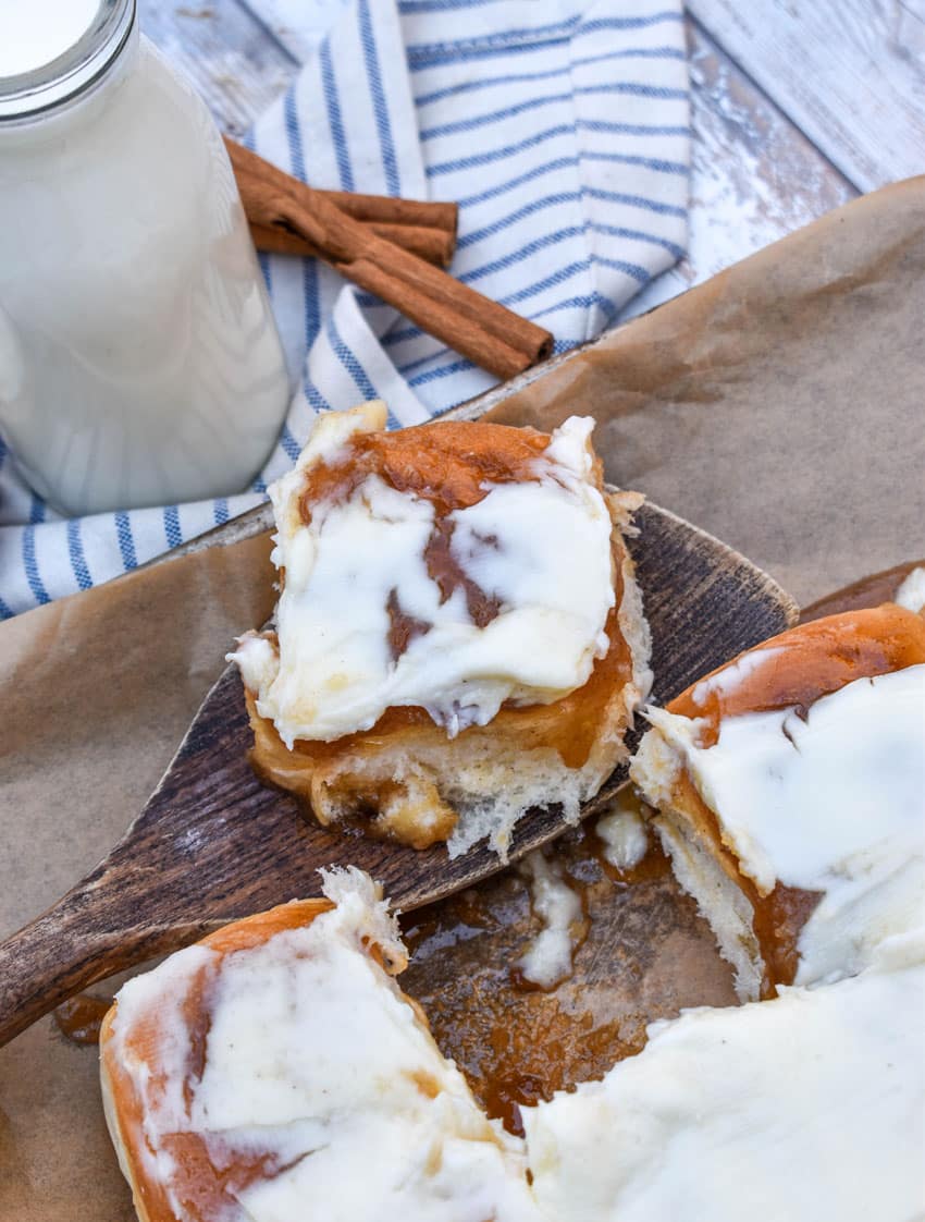King's hawaiian cinnamon rolls on a parchment paper lined baking sheet