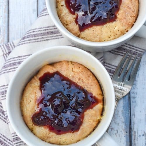 peanut butter and jelly mug cakes in two white mugs