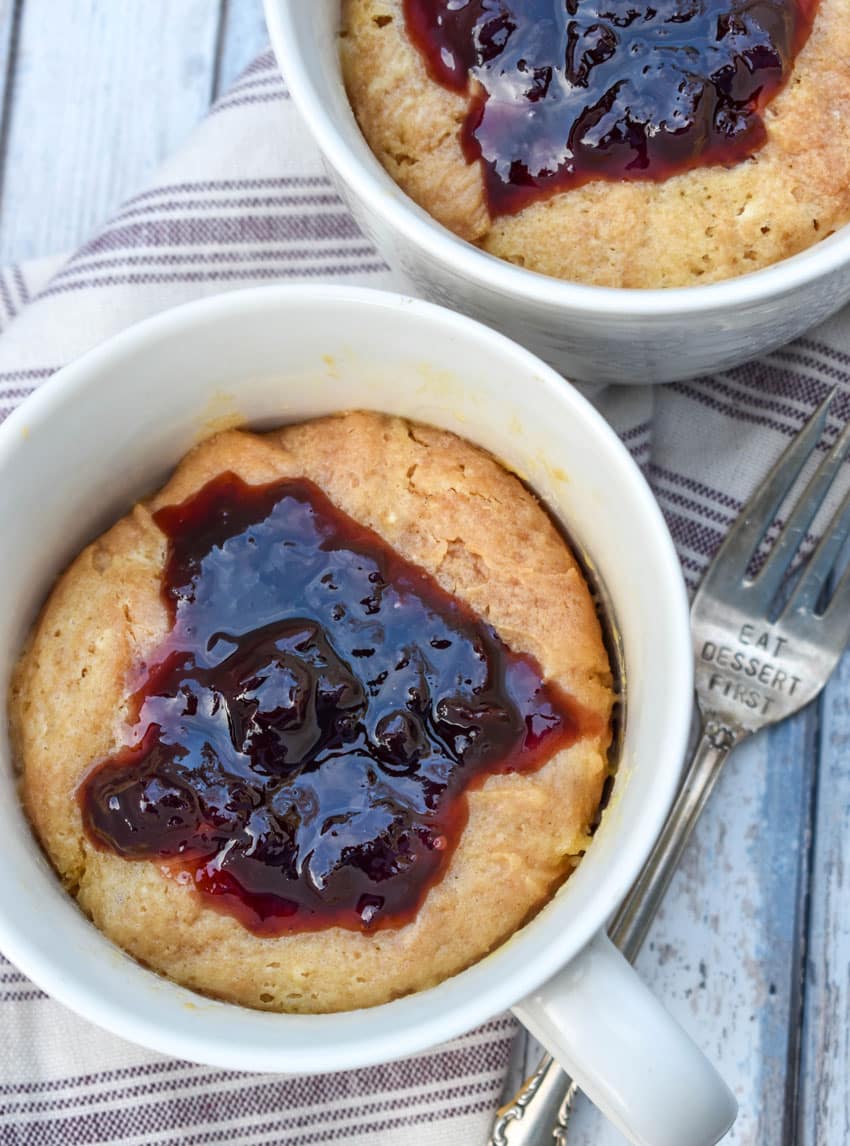 peanut butter and jelly mug cakes in two white mugs