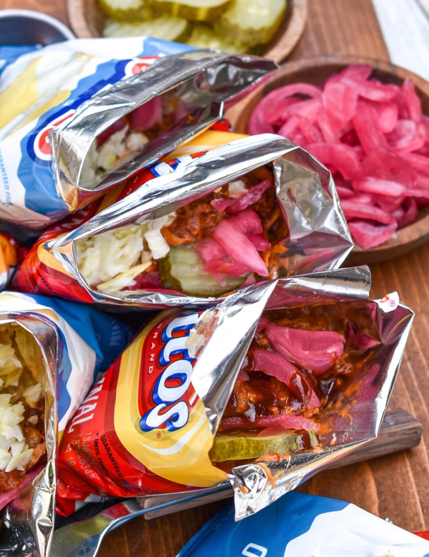 pulled pork walking tacos on a metal tray