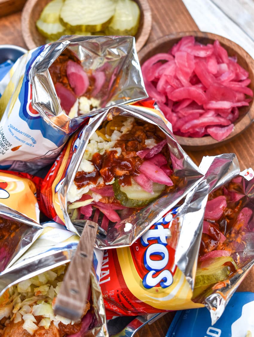 pulled pork walking tacos on a metal tray