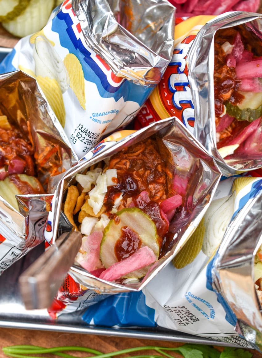 pulled pork walking tacos on a metal tray