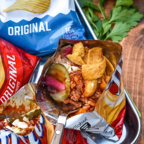 pulled pork walking tacos on a metal tray