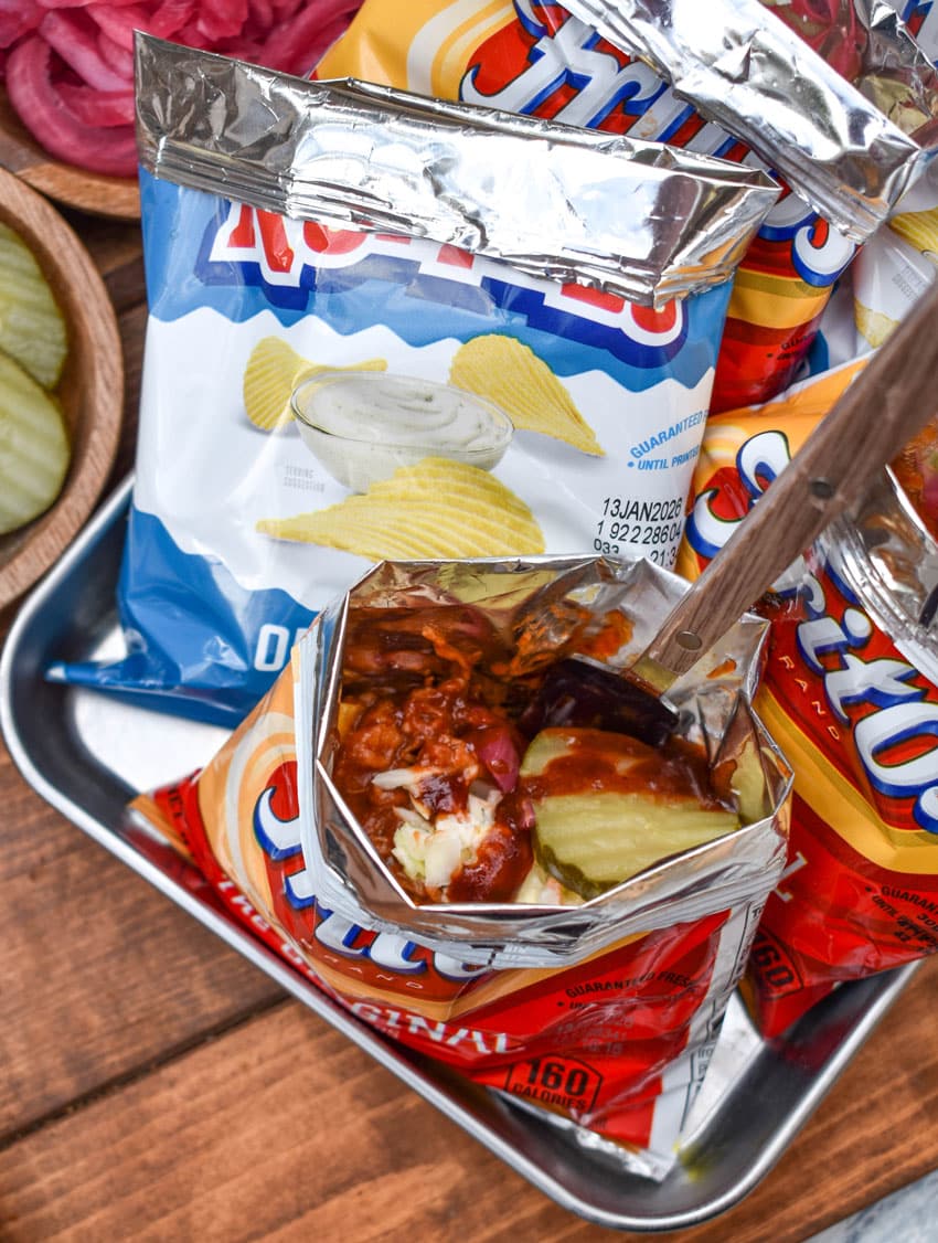 pulled pork walking tacos on a metal tray