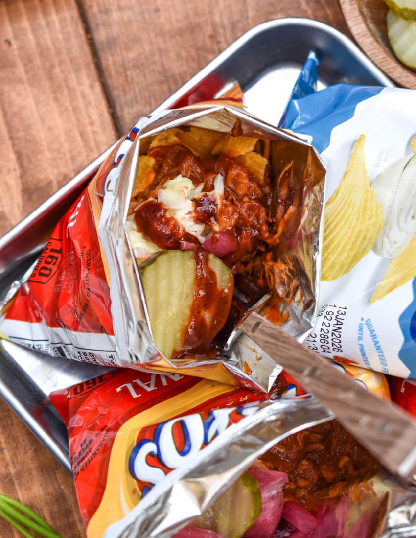 pulled pork walking tacos on a metal tray