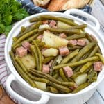 slow cooker green beans with ham in a white serving bowl