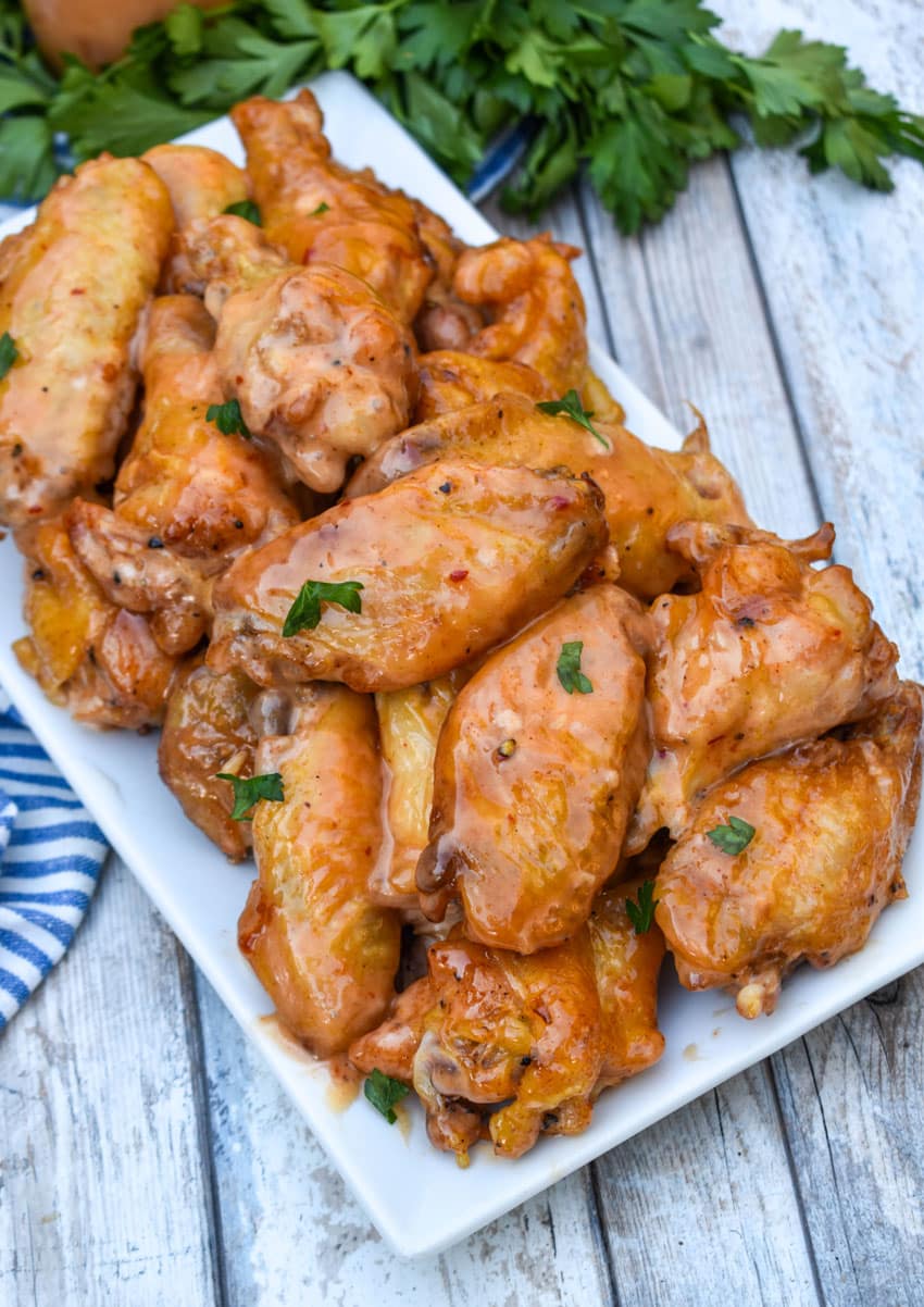 bang bang chicken wings piled high on a white serving platter