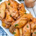 bang bang chicken wings piled high on a white serving platter