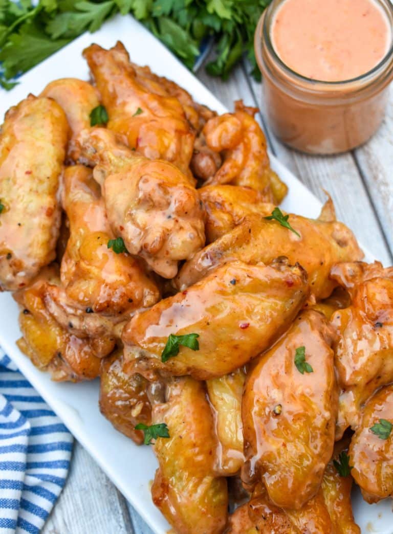 bang bang chicken wings piled high on a white serving platter