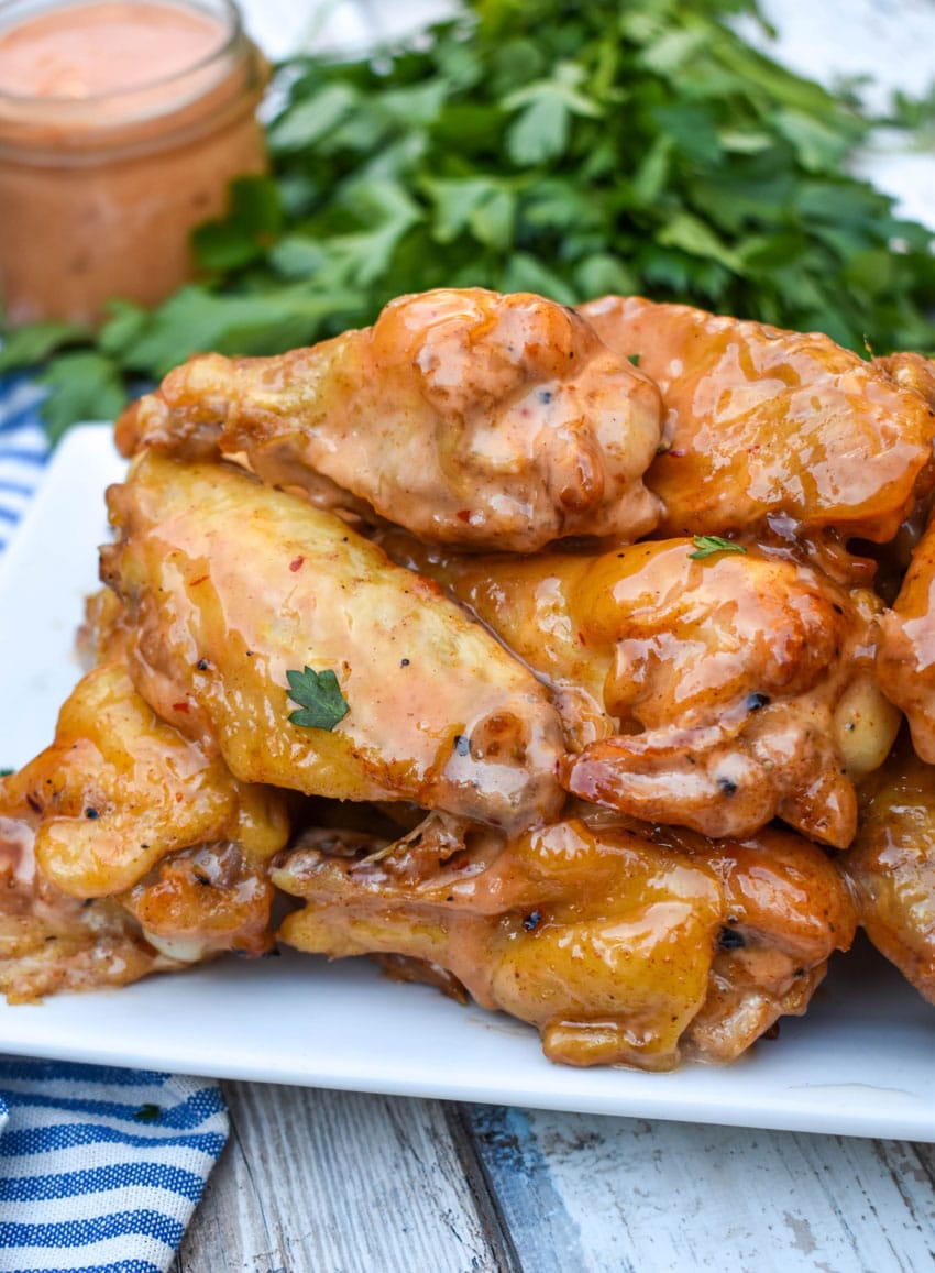 bang bang chicken wings piled high on a white serving platter