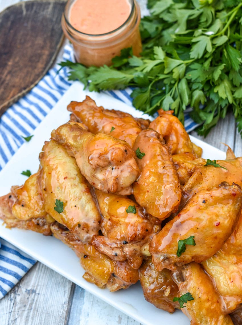 bang bang chicken wings piled high on a white serving platter