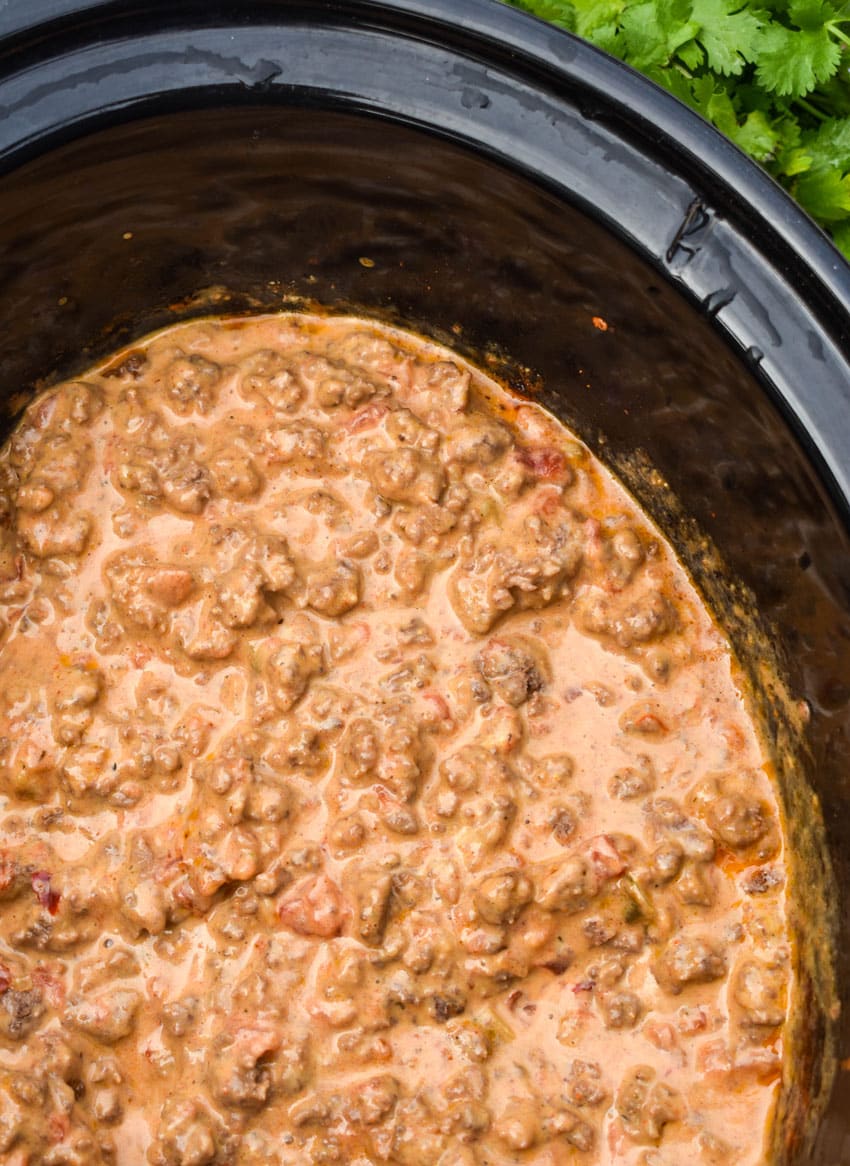 cheesy rotel beef taco meat in the black bowl of a slow cooker
