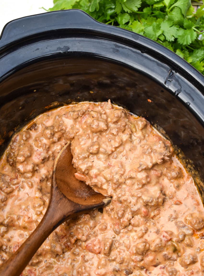 cheesy rotel beef taco meat in the black bowl of a slow cooker