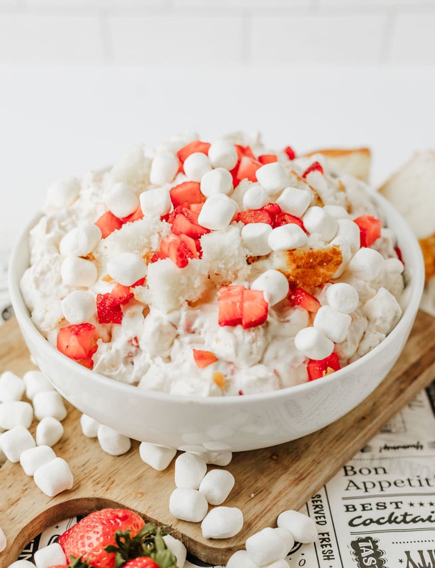 strawberry shortcake fluff salad in a white serving bowl