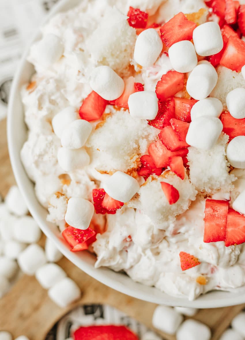 strawberry shortcake fluff salad in a white serving bowl