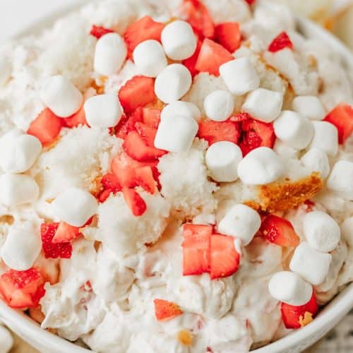 strawberry shortcake fluff salad in a white serving bowl