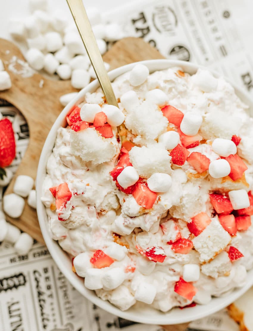 strawberry shortcake fluff salad in a white serving bowl